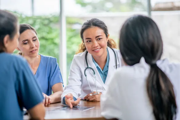A medical team discussing a case during a meeting.