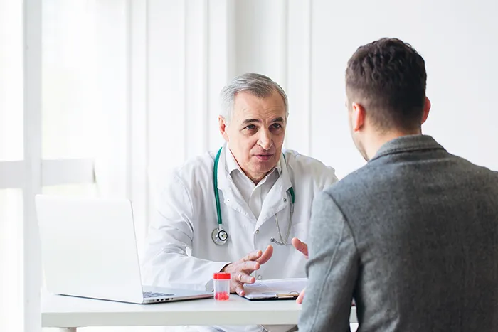 A doctor consulting with a patient in an office.