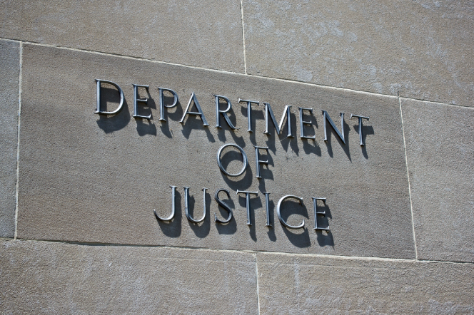 Sign on the exterior identifies the Department of Justice.